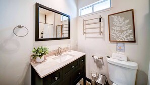 Our full bathroom with a walk-in shower, heated towel rack, and full vanity will make it easy for you to feel right at home. 
