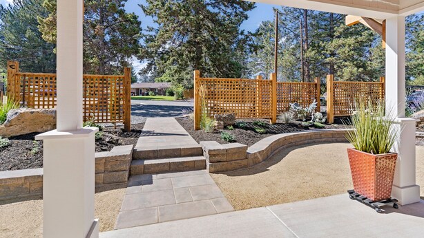A covered patio area with wooden lattice fencing, stone steps, and a potted plant. - Top 5%  - Finnish Sauna - Near Old Mill - No Pets - Fully Remodeled - Quiet (Bend)