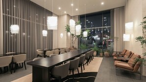 A modern conference room with a long table, chairs, and hanging pendant lights. - Anook Signature Hotel Incheon Guwol (Incheon)
