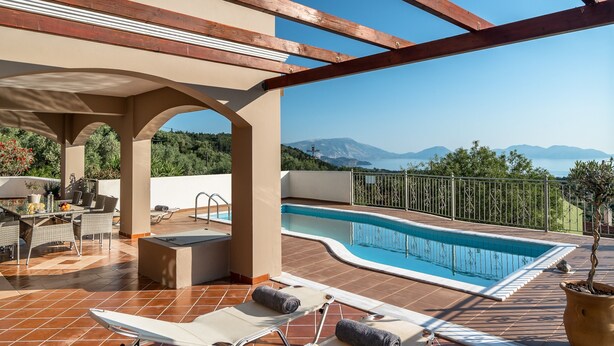 A rooftop pool area with a view of mountains, a covered seating area, and a poolside bar. - Villa 'Kumusha' with Sea View, Pool, Garden & Wi-Fi (Kefalonia)