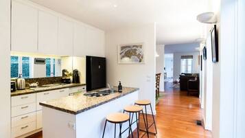 Fridge, dishwasher, coffee/tea maker, cookware/dishes/utensils