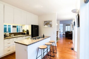 Fridge, dishwasher, coffee/tea maker, cookware/dishes/utensils