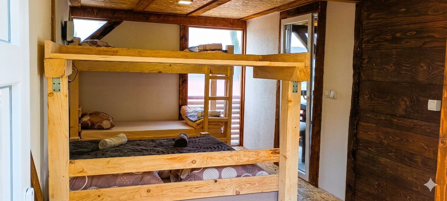 A bunk bed with a wooden frame, a window, and a door.