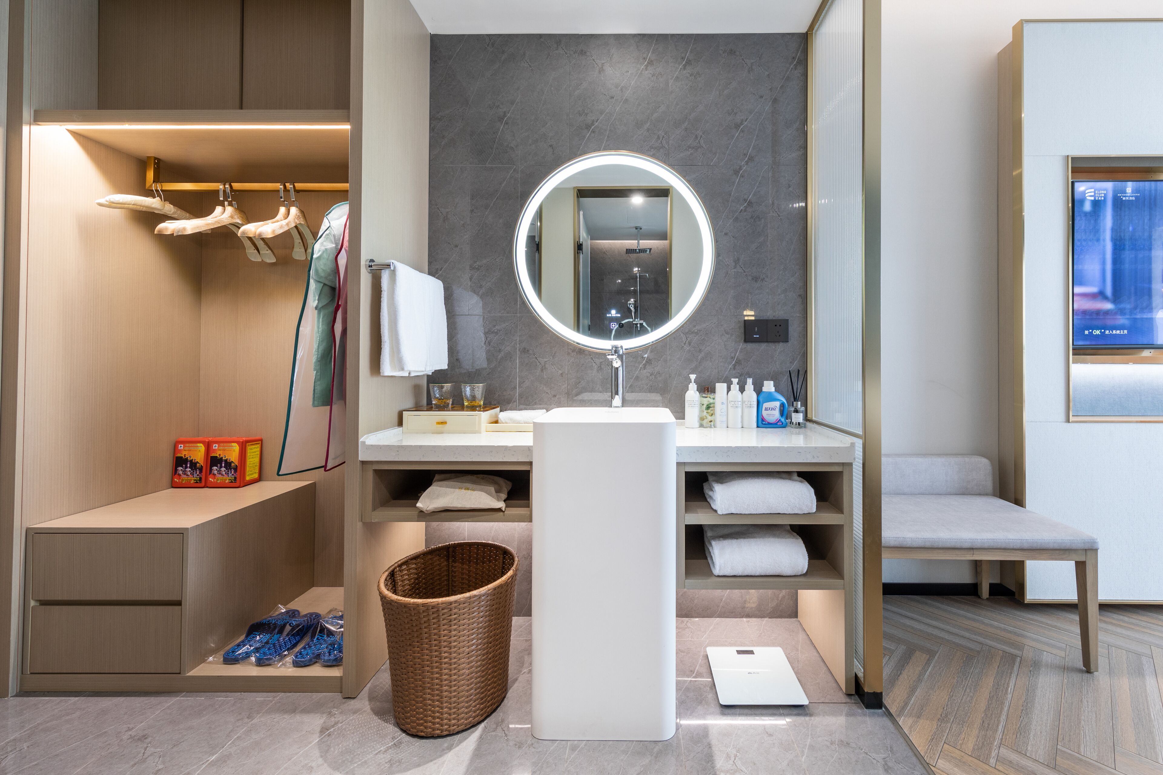 A modern bathroom with a vanity, mirror, and storage.