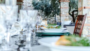 A table set for a meal with plates, glasses, and cutlery. - Villa Le Croci beautiful tuscan villas with infinity p/pool (Croci Di Calenzano)