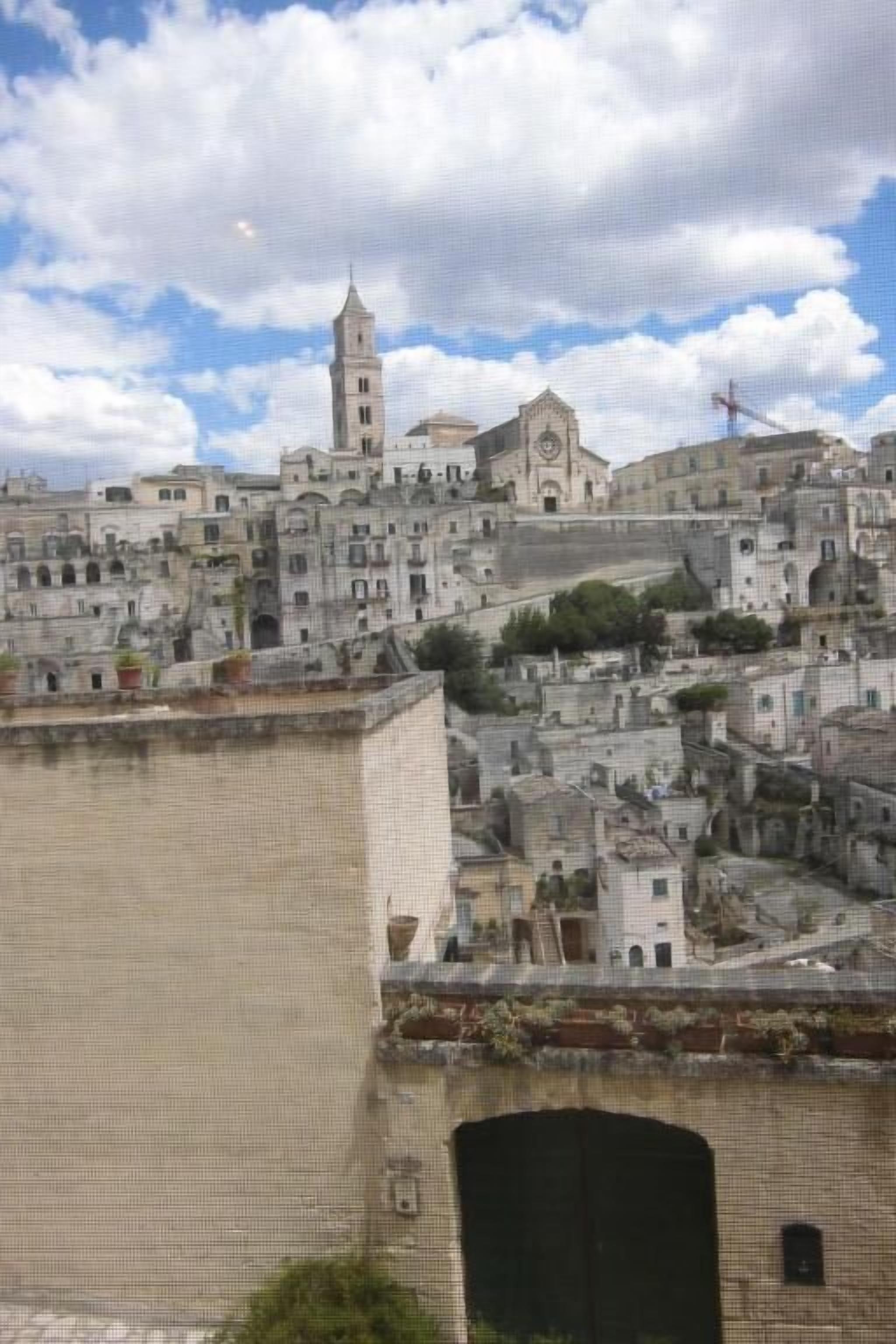 A densely packed urban area with historic buildings, including a prominent church with a bell tower.