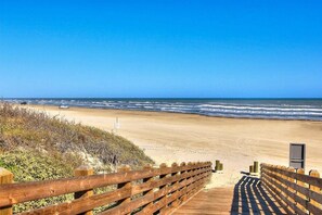 Walk along the boardwalk to the sandy beach.