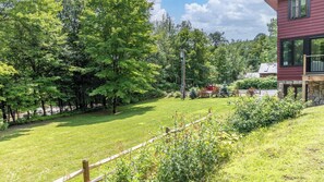 Surrounded by lush trees and a well-manicured lawn, this serene setting offers a peaceful escape.