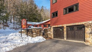 A red building with stone walls, a sign for The Inn at Turner Mill, and a snow-covered landscape. - Vermont 2BR | Stowe Slopes & Swimming Holes (Stowe)