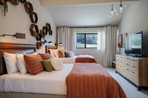 A hotel room with two beds, a TV, and a window with a view of buildings. - SV711 | Nice Views | Amazing location | Hot Tub | Ski In/Out | A/C (Steamboat Springs)