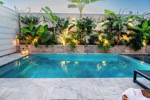 A heated pool, pool loungers