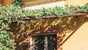 A building facade with a sign reading "FORTST" and a window above it. - AGRITURISMO FOREST B&B (Iseo)