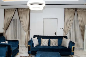 Executive Apartment | Living area | 65-inch Smart TV with cable channels, TV, Netflix - Focus Holiday Inn (Abuja)