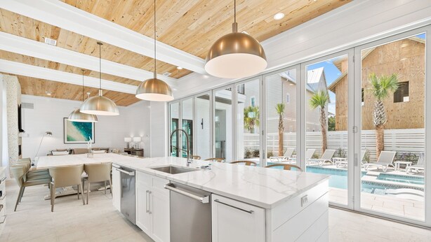 A modern kitchen with a large island, stainless steel appliances, and pendant lighting. - Bullish on Beaches|Easy Beach Access|Stunning Views|New Construction (Inlet Beach)
