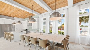 A spacious kitchen with white cabinets, a large island, and pendant lighting. - Bullish on Beaches|Easy Beach Access|Stunning Views|New Construction (Inlet Beach)