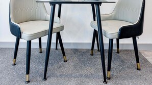 A dining table with two chairs, each with a different color upholstery, and a pair of glasses and bowls on the table. - Fantastic 1 Bed Apartment in Wolverhampton (Wolverhampton)