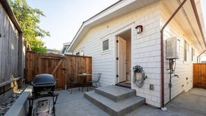 A patio with a grill, outdoor seating, and a water heater. - Harbor House A, overlooking Santa Cruz Harbor (Santa Cruz)