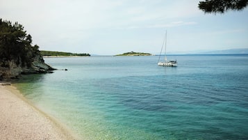 En privat strand, liggestole, parasoller