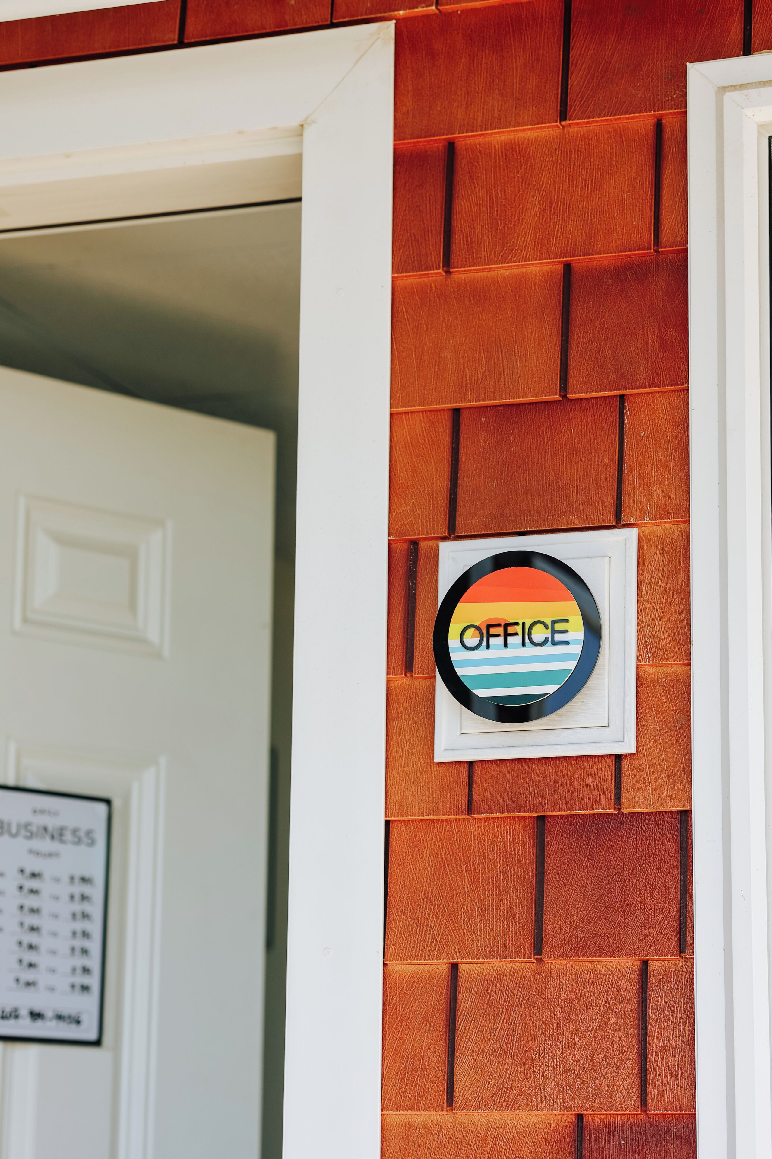 A door with a sign that reads 'OFFICE' and a white door in the background.