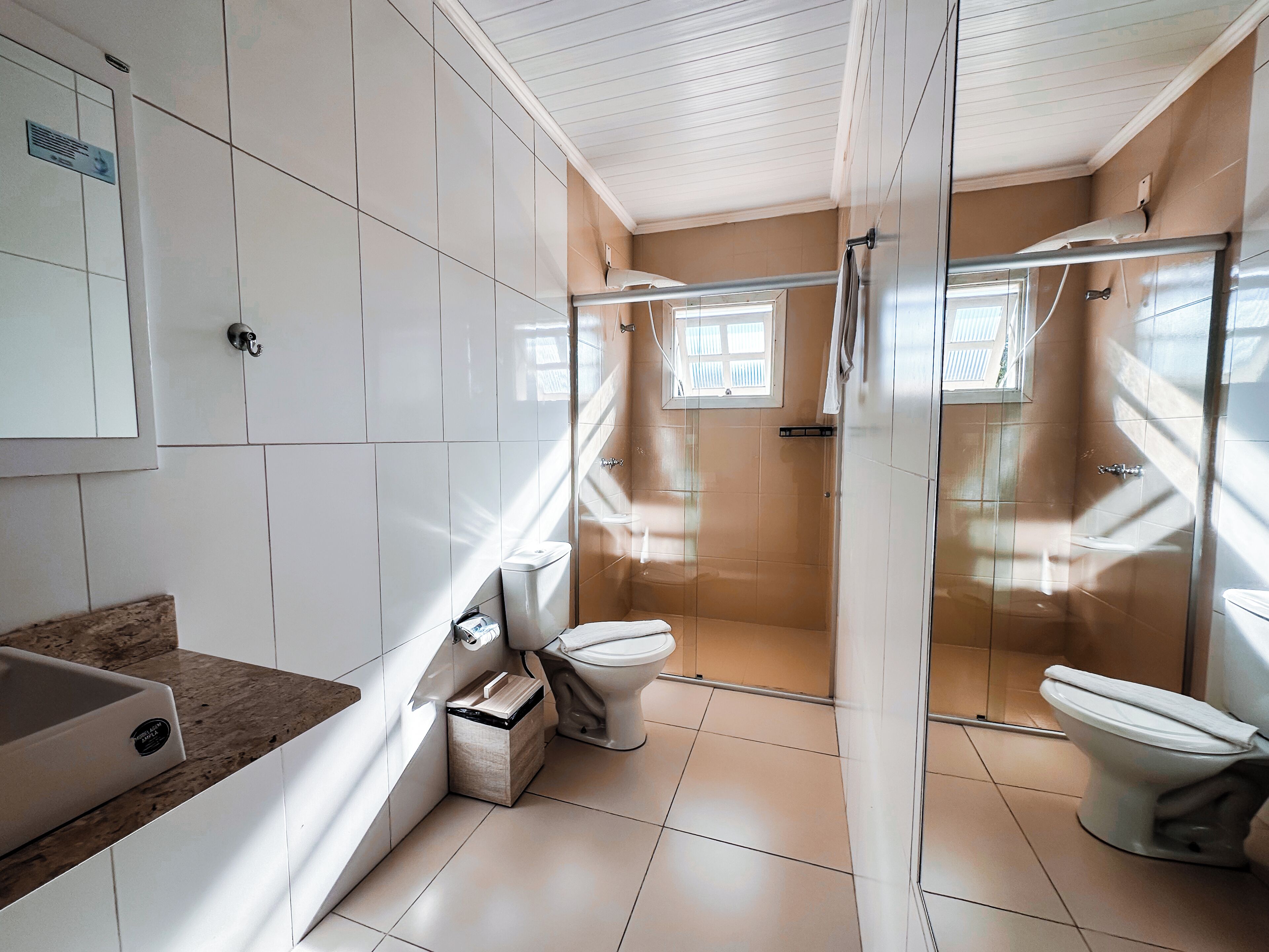 A bathroom with a shower, toilet, and sink.