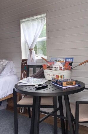 Relax in this serene room with a comfortable bed and a stylish table featuring a charming basket of personal touches.
