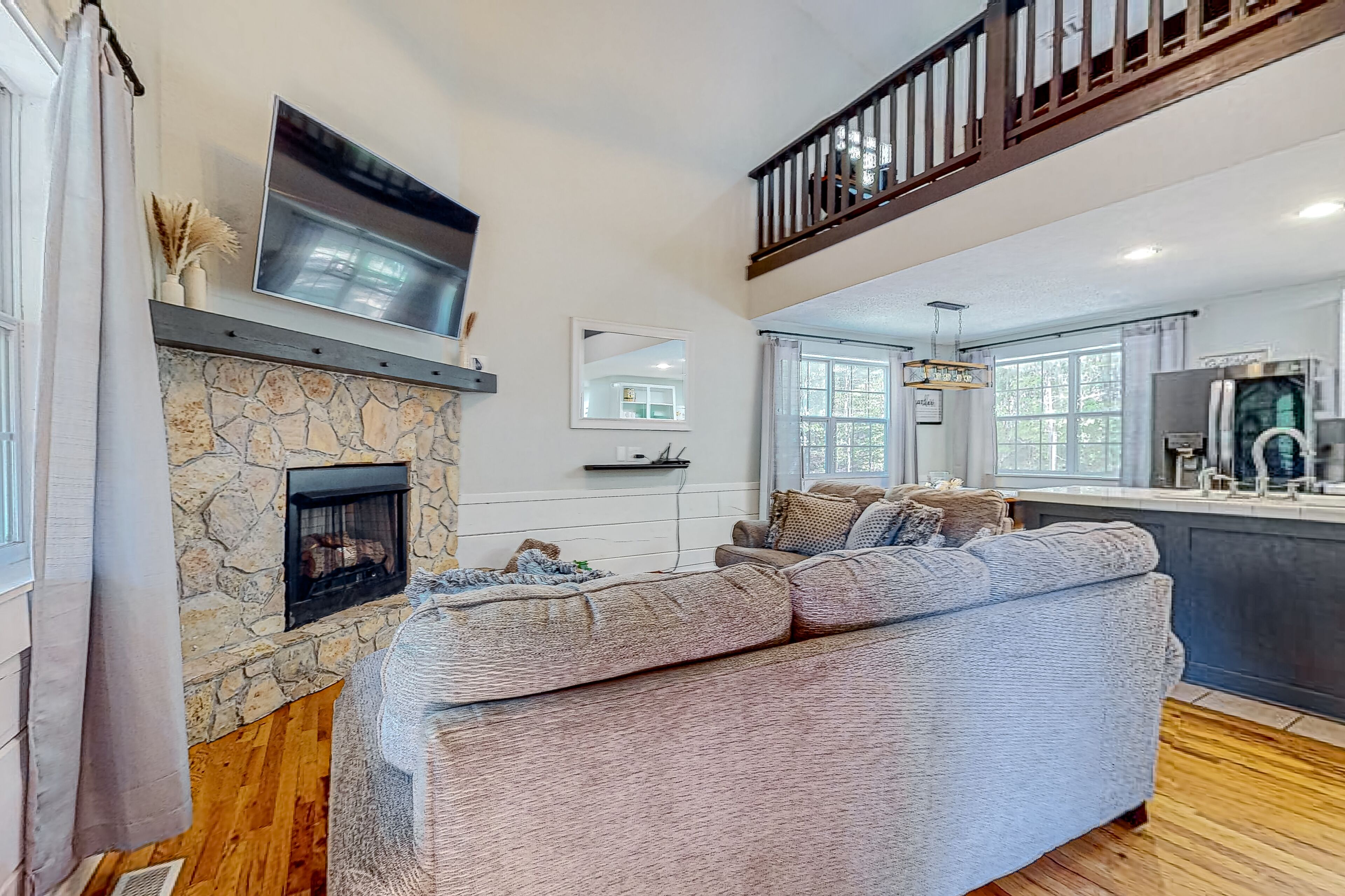 Charming home lined by trees with a large deck, grill, firepit, & pool table