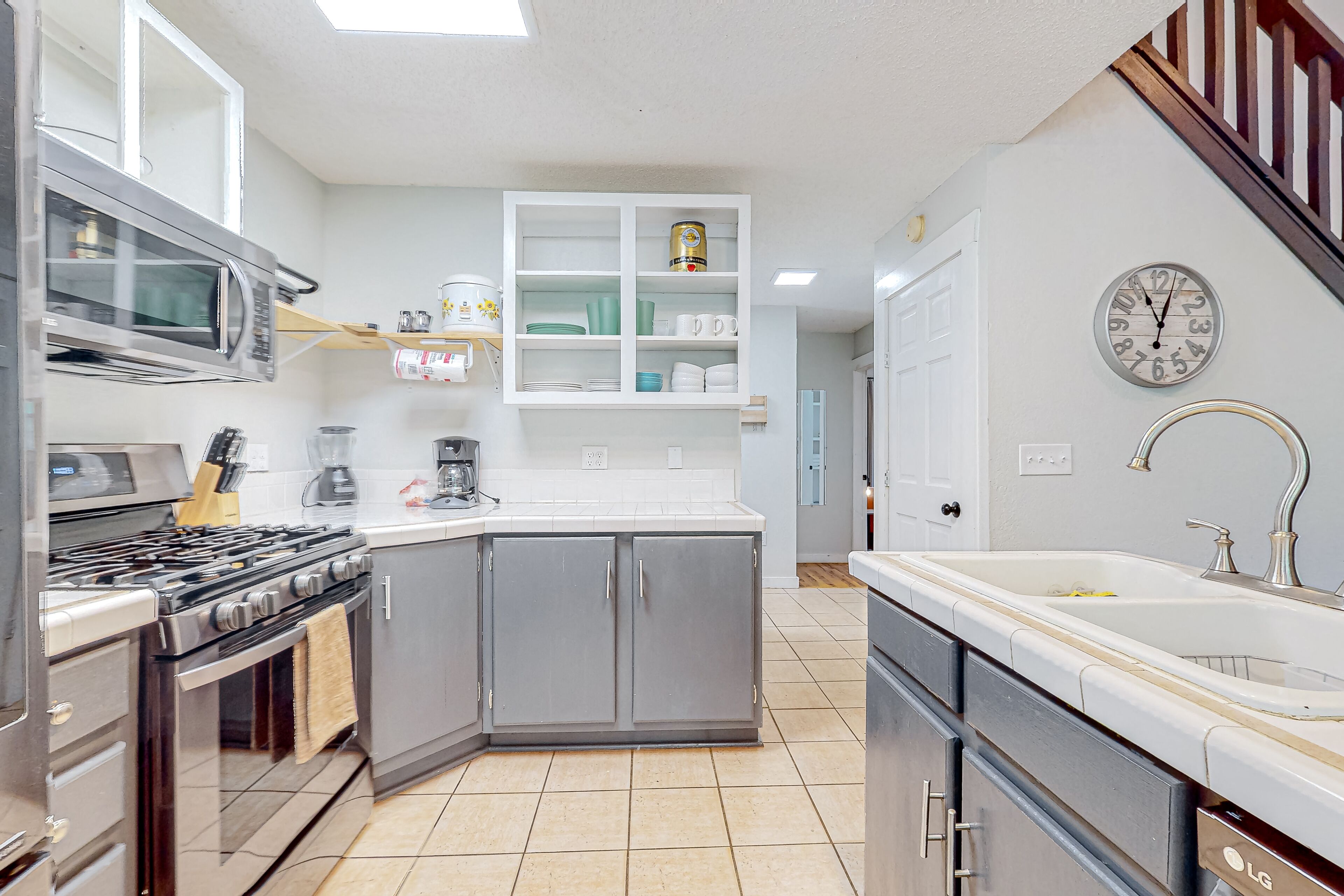 Charming home lined by trees with a large deck, grill, firepit, & pool table