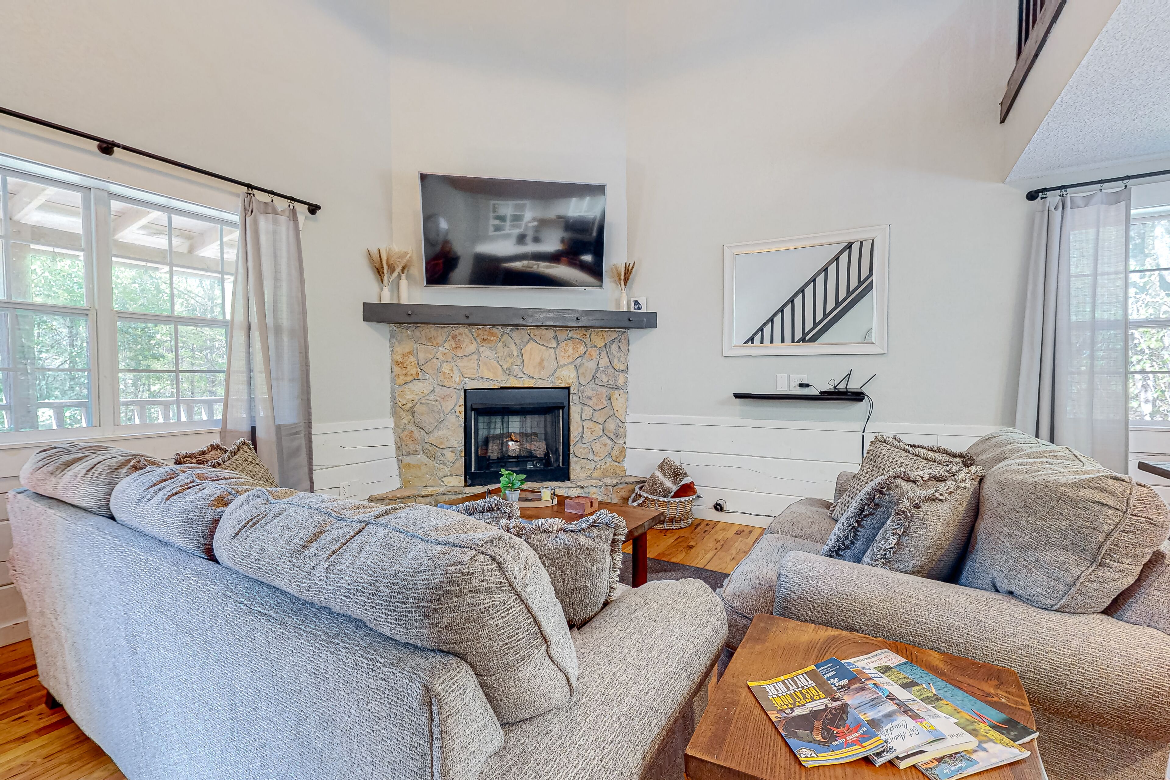 Charming home lined by trees with a large deck, grill, firepit, & pool table