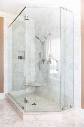 Bathtub, hair dryer, towels, shampoo