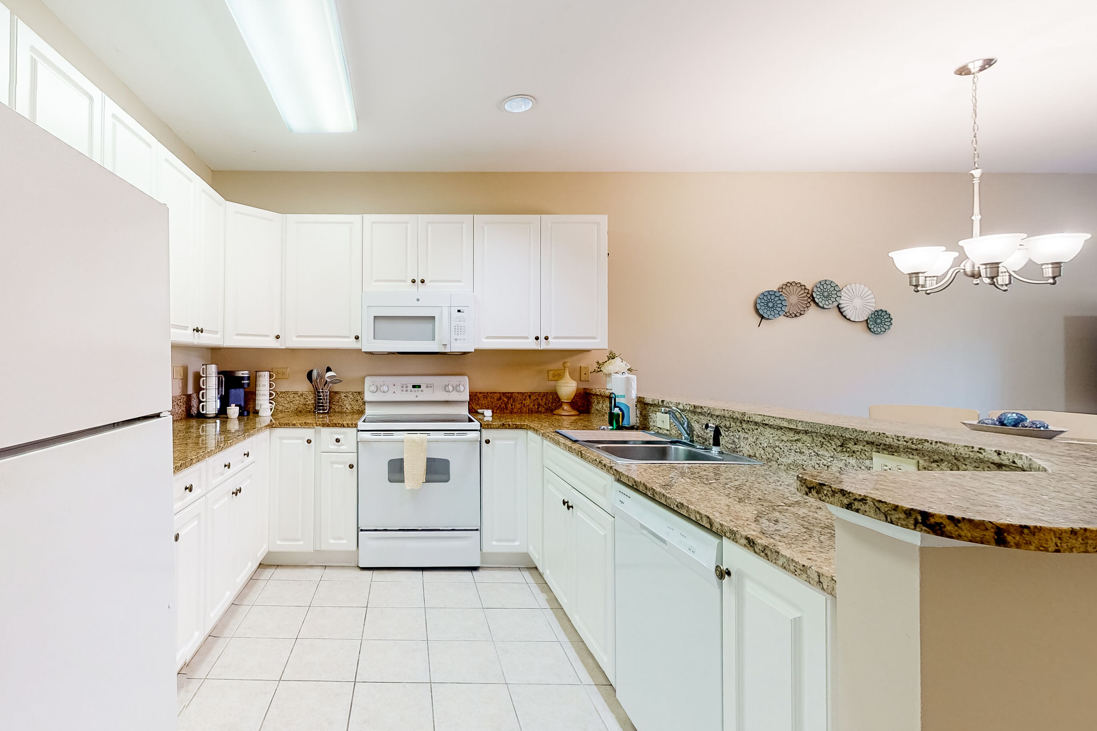 Ground-floor golf course condo with fairway views, pool access, & private patio