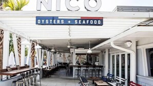 A restaurant named 'NICO' with a sign indicating it serves oysters and seafood. - Palmetto Grove,  Walk to Shem Creek, Mins to Dwt (Mount Pleasant)