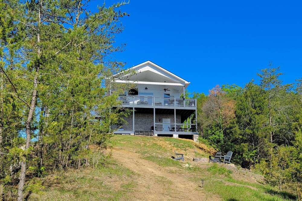 Scenic outdoor home with dock access, hammocks, large deck, fire pit, & hot tub