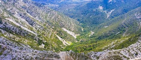 A mountainous landscape with a valley and a road.