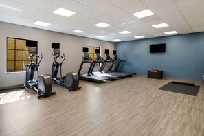 A gym with treadmills, elliptical machines, and a yoga mat area. - Hampton Inn Concord (Concord)