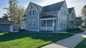 A two-story house with a front porch and a well-maintained lawn. - Location, Location in cedarburg (Cedarburg)