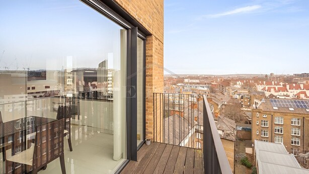 A modern apartment with a large balcony, glass walls, and a view of the cityscape. - Still Life Euston Deluxe (London)