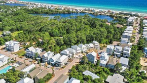 A coastal residential area with houses, a beach, and a lake. - 30A - The Charming Blue Haven by PHG (Santa Rosa Beach)