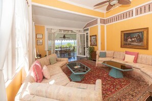 A living room with a sofa set, a coffee table, and a patterned rug.
