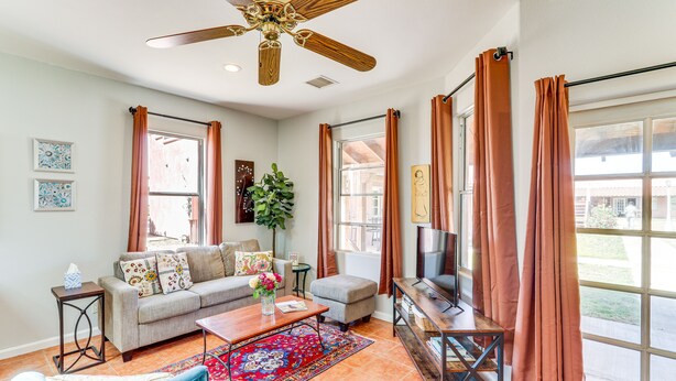 A living room with a sofa, coffee table, TV, and a ceiling fan. - Arizona Desert Vacation Rental w/ Pool Access! (Eloy)