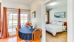 A room with a dining table, chairs, a bed, and a window with curtains. - Arizona Desert Vacation Rental w/ Pool Access! (Eloy)