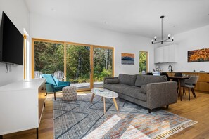Relax in a spacious living area with a sofa and coffee table, or dine near a scenic view through the sliding glass door.