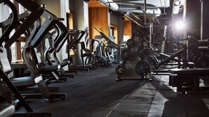 A gym with various exercise equipment including treadmills, weight machines, and free weights. - Avari - Luxury 2BR Apartment • Steps from Victoria (London)