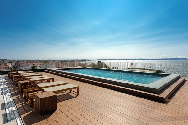 Una piscina al aire libre, sillones reclinables de piscina