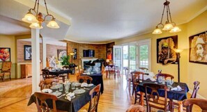 Enjoy group dining or social events in this spacious dining area with high ceilings and exposed brick walls.