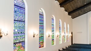 A church interior with stained glass windows and pews. - La Palmilla Texas (Glen Rose)