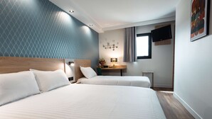 A hotel room with two beds, a small desk, a TV, and a window with curtains. - Kyriad Direct Orleans Nord - Cap Saran (Saran)
