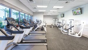 A gym with treadmills, ellipticals, and weight machines.