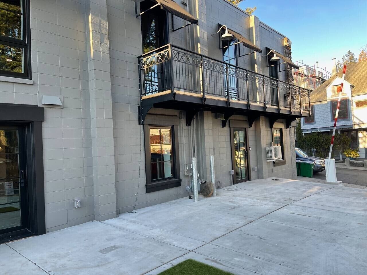 A multi-story building with a balcony on the second floor.