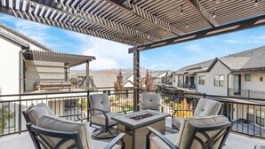 A covered patio with outdoor furniture, a fire pit, and a view of neighboring houses. - Waterpark overlook with patio, firepit, pickleball (Santa Clara)