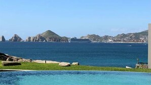 A coastal hotel with a swimming pool, rocky outcrops, and a clear view of the sea. - MILLION DOLLAR VIEW PENTHOUSE 2BDR, 2 BTH  (Cabo San Lucas)